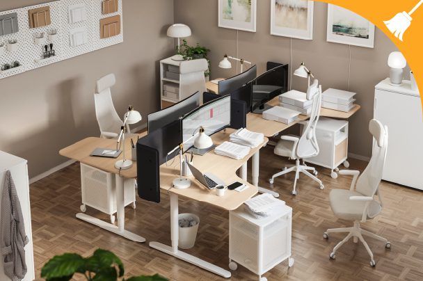 Modern office workspace with four desks, ergonomic chairs, computer monitors, and desk lamps arranged in a clean, organized setting.